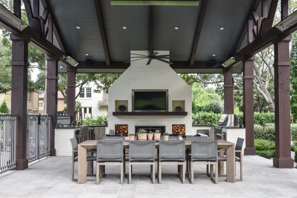 Outdoor loving space with a kitchen and large fireplace making it the perfect summer get-away! Remolded by Houston's best, LBJ Construction.